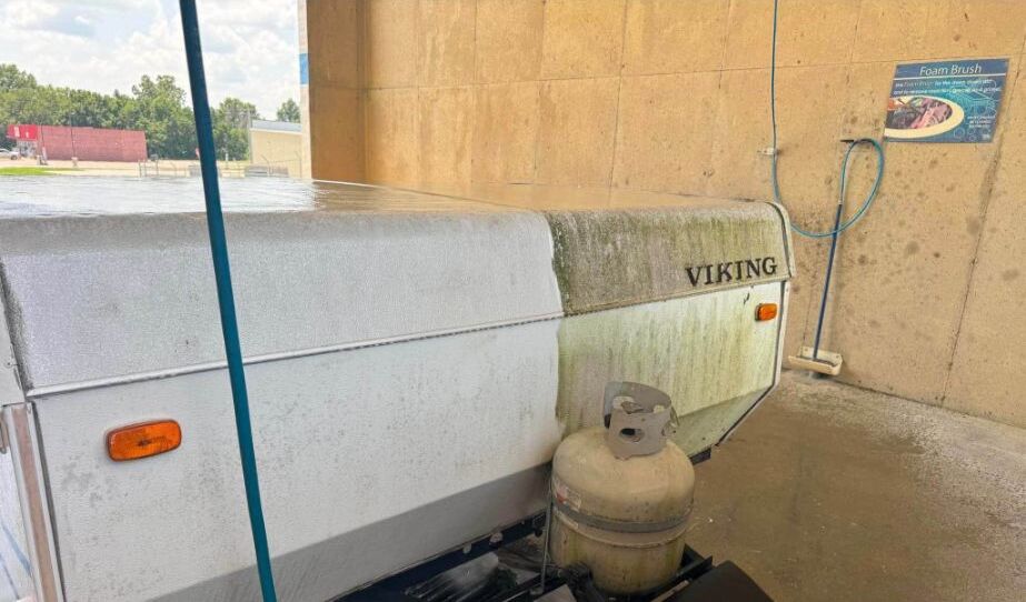 Viking pop-up camper before cleaning at a wash bay
